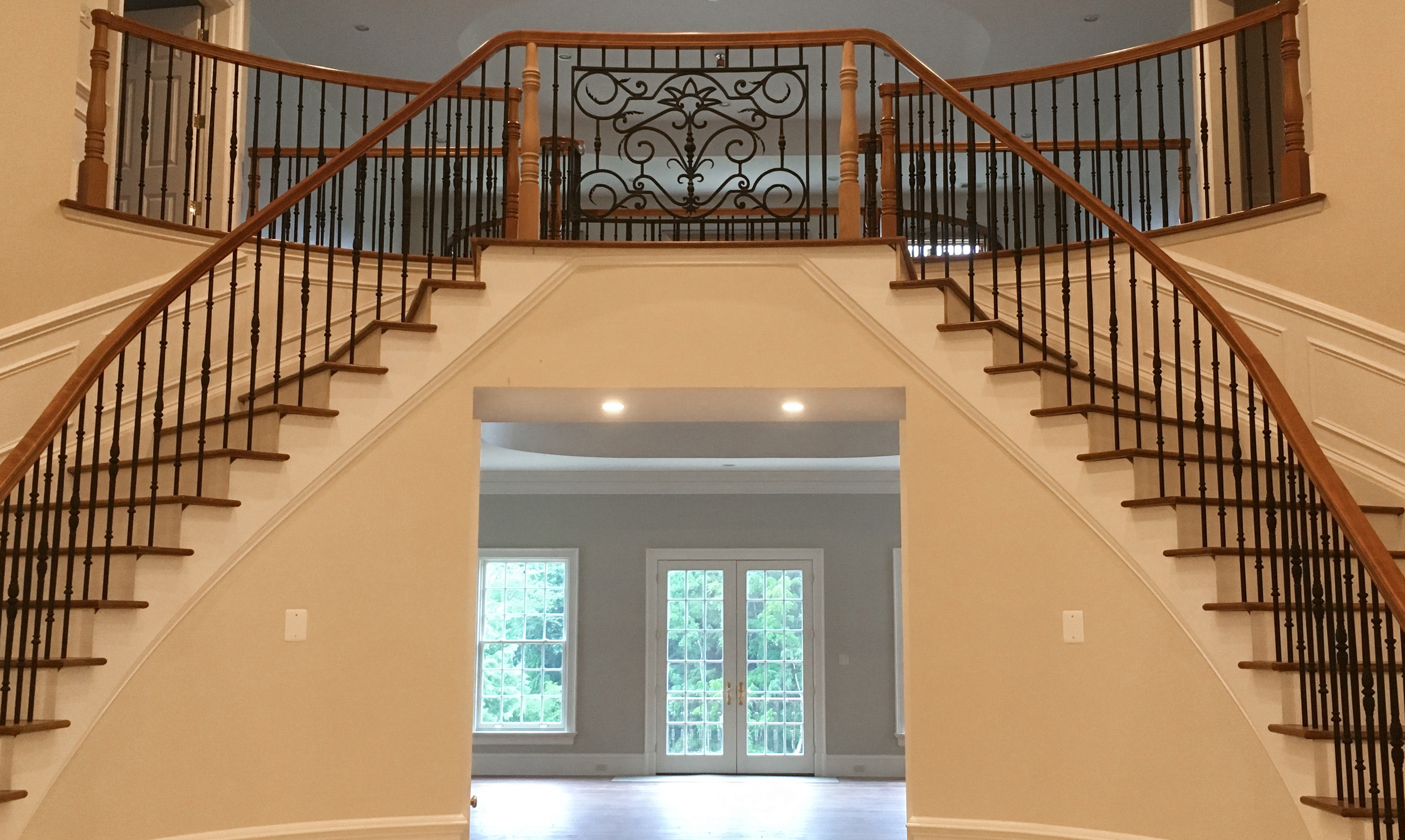 large dual winding staircase from the main floor
