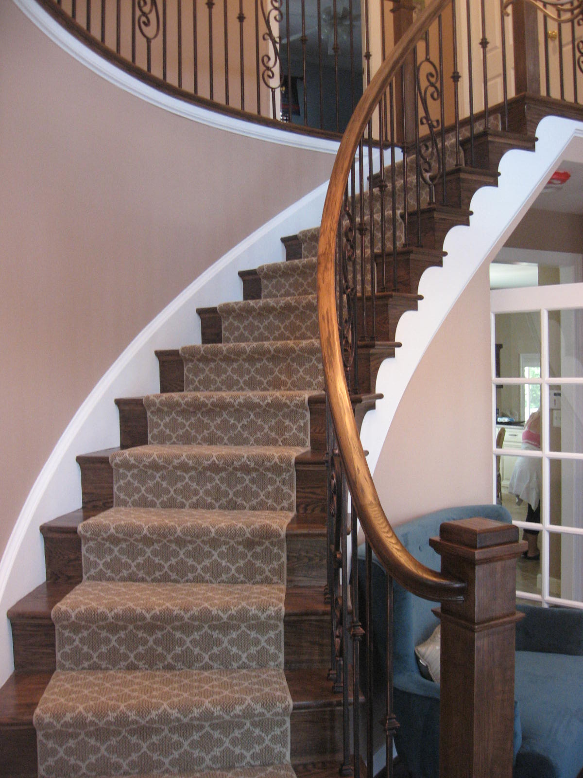 wood stair and rails with carpet runner and metal balusters