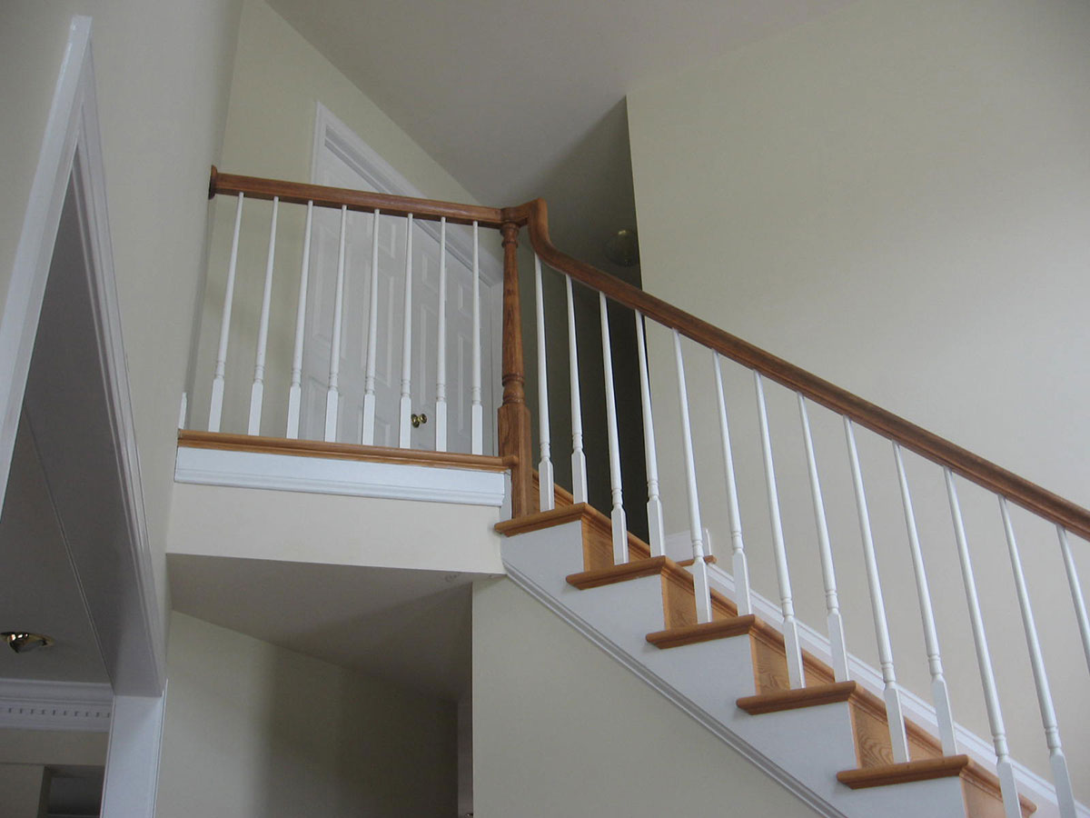 staircase before picture with white wood balusters